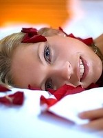 Blond bitch laying naked on the bed of roses